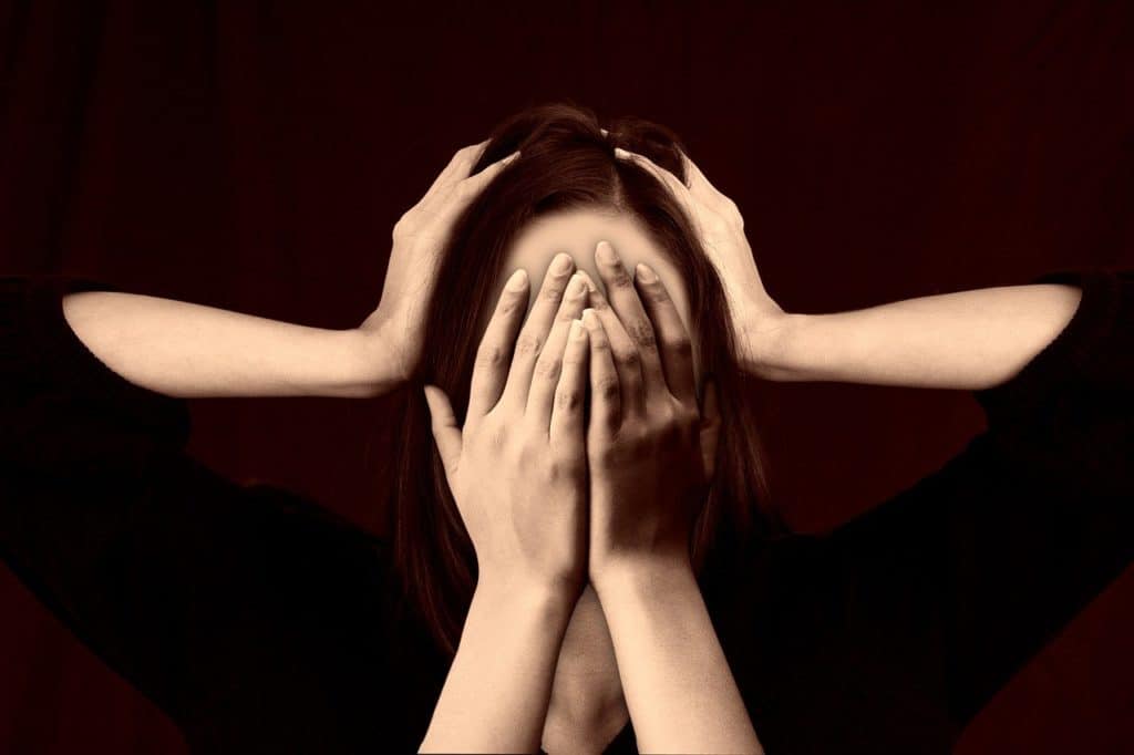 Person covering their face with many hands, overwhelming emotions, Borderline Personality Disorder therapy in Ontario